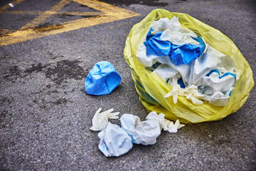 Yellow trash bag of biohazard medical waste on the street, environmental pollution due to the flu pandemic.