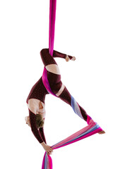 Portrait of young woman, air gymnast training, performing on special ribbon isolated over white...