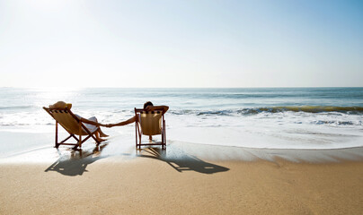 Fototapeta na wymiar Couple sunbathing on a beach chair.
