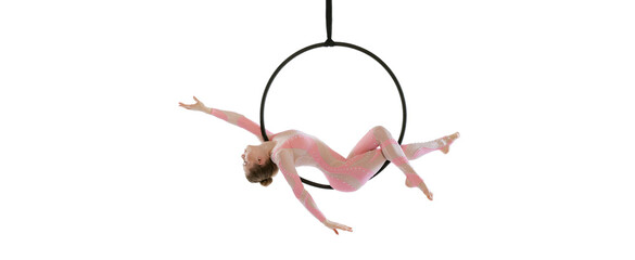 Portrait of young sportive girl, air gymnast performing on hoop isolated over white studio...