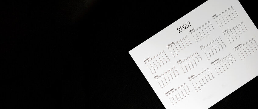 Close up 2022 calendar with banner size and copy space black background, schedule arrangement and manage appointment, timetable, timeline, planner agenda and payment reminder in advance