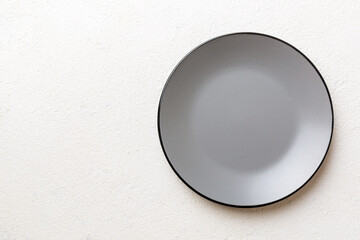 Top view of empty grey plate on cement background. Empty space for your design