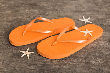 Beach accessories. Flip flops and starfish on colored background. Top view Mock up with copy space