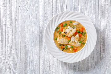 white fish chowder with green peas, potatoes