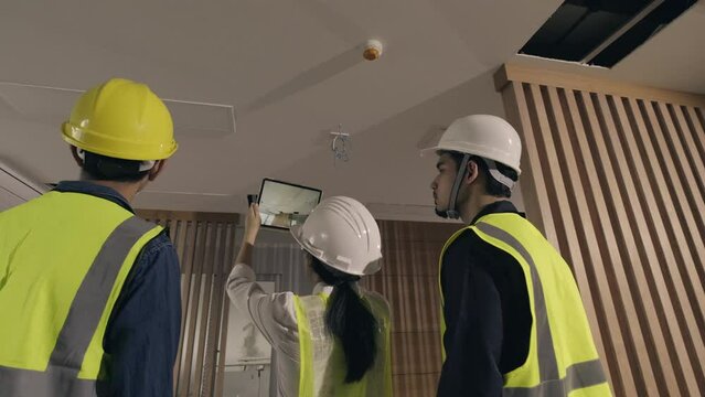 Team work Asian people Engineer or Architect team inspector building inspection with tablet at construction site work. Concept augmented reality technology in construction business.