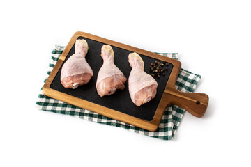 Raw chicken meat legs on cutting board isolated on white background	
