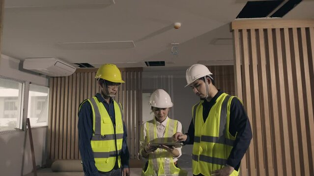 Team work Asian people Engineer or Architect team inspector building inspection with tablet at construction site work. Concept augmented reality technology in construction business.