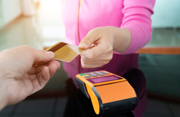 Close up of hand paying with credit card