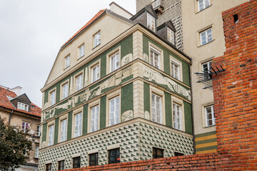 Warsaw, Poland, 13 October 2021: picturesque street with colorful buildings in historic center in medieval city, renaissance and baroque historical buildings near Barbican fortifications, sunny day
