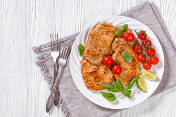 tomato basil pesto fried pork cutlets on plate