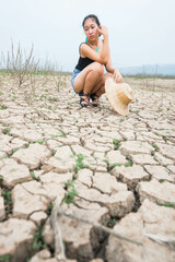 woman portrait in dryland with drought ground texture. concept climate changed.