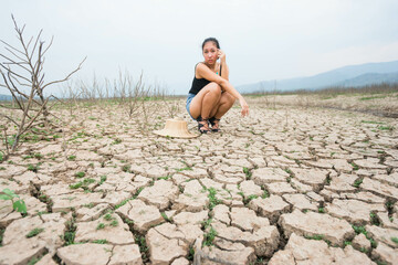 woman portrait in dryland with drought ground texture. concept climate changed.