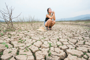 woman portrait in dryland with drought ground texture. concept climate changed.