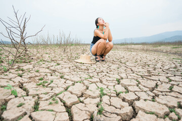 woman portrait in dryland with drought ground texture. concept climate changed.