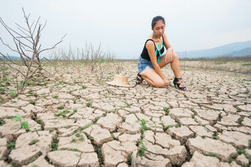 woman portrait in dryland with drought ground texture. concept climate changed.