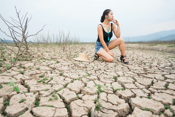 woman portrait in dryland with drought ground texture. concept climate changed.