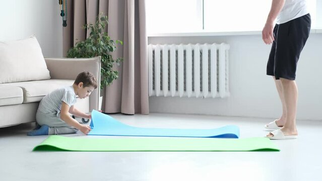 Active fit young father and son follow healthy lifestyle exercise taring together. Sport concept. Man and Boy Train at Home.