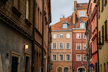 Fototapeta na wymiar Warsaw, Poland, 13 October 2021: Narrow picturesque street with colorful buildings in historic center in medieval city, renaissance and baroque historical buildings at old town, sunny autumn day