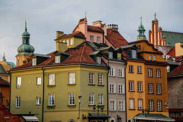 Warsaw, Poland, 13 October 2021: picturesque street with colorful buildings in historic center in medieval city, renaissance and baroque historical buildings at castle square, sunny day