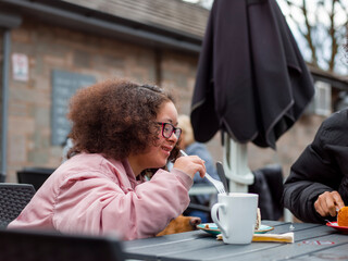 Girl eating cake in cafe