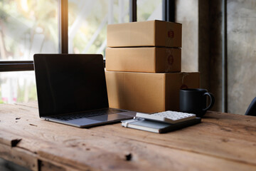 Equipments for SME online business , delivery business laptop, barcode, boxes, checking product on stocks or parcels. Small business working at home office.