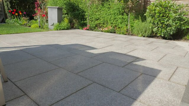 Tiled patio deck with sunlight in time lapse.