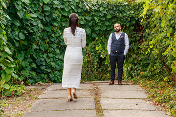 Fototapeta premium a girl in a wedding dress goes to meet a guy in the park