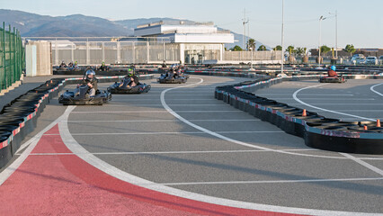People racing karting cars on go-kart tracks