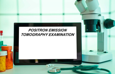 Medical tests and diagnostic procedures concept. Text on display in lab Positron Emission Tomography Examination