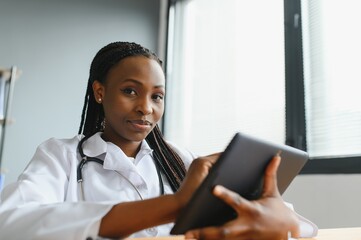 African female doctor talk with patient make telemedicine online webcam video call. Woman therapist videoconferencing on computer in remote telemedicine laptop virtual chat. Telehealth concept.