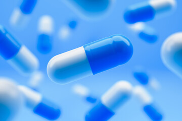 Blue white pills falling on a blue background. 3D rendering.