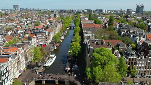 Amsterdam canals, streets and landmarks. Old centre aerial view. Famous places to see in Netherlands. Sunny summer day in Amsterdam, citybreak destination in Holland.
