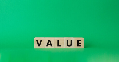 Value symbol. Concept word value on wooden cubes. Beautiful green background. Business and value concept. Copy space.