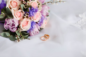 Wedding flowers, bridal bouquet and rings close-up. Decoration of roses and ornamental plants, close-up, selective focus, nobody, objects