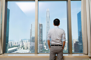 Businessman standing in front of the window