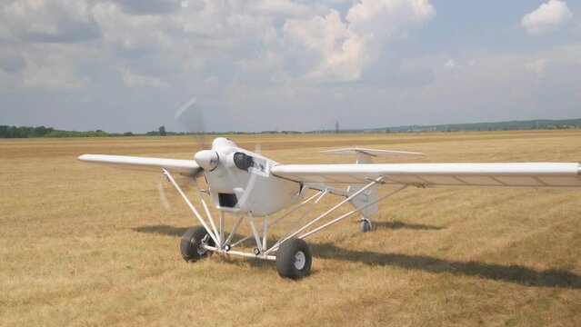 Unmanned aerial vehicle. UAV delivery drone cargo. The plane leaves the field for takeoff. The compact device on gasoline. The propeller is spinning at the aircraft engine