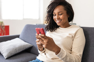 Mixed race young woman using smart mobile phone at home - Teenager girl reading message in smartphone device