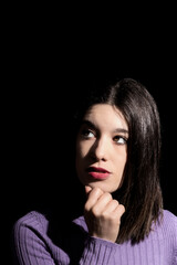 pensive brunette woman with black background