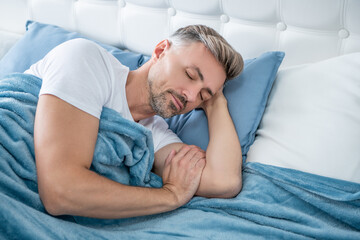 grizzle man sleeping in bed. early morning