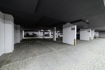 underground parking for vehicles with cobblestones and black ceiling