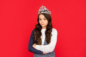 serious child in queen crown. expressing smug. arrogant princess in tiara. proud kid.