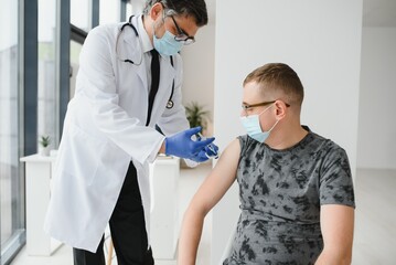 Man with face mask getting vaccinated, coronavirus, covid-19 and vaccination concept