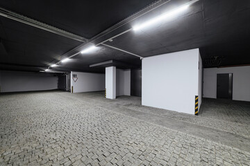 new empty underground car park with lighting and natural stone