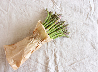 Raw organic asparagus in the paper bag. Asparagus background. Food concept.