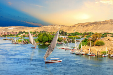 Sailboats in front of the hills of the Nile in Aswan, Egypt