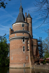 Round beautiful intact tower next to remains of picturesque Duurstede moated castle with architectural detail of the structure fortified building