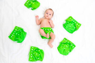 Reusable diaper on the baby copy space . An article about reusable diapers. Saving on diapers. Concern for the environment. Eco-products. - obrazy, fototapety, plakaty