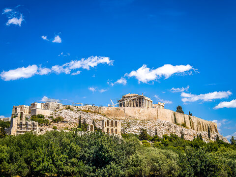 Parthenon temple was one of the seven wonders of the world in antiquity. A sunny day in Athens, Greece, with some tiny clouds travelling in the blue sky.