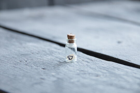 Valentines Day vintage background. Small bottle with a heart.