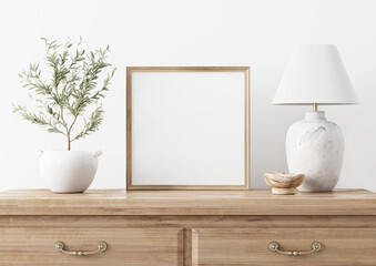 Square wooden frame mockup in traditional living room interior with classic chest of drawers, marble lamp and small olive tree on white wall background. Illustration, 3d rendering